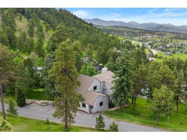 Stunning exterior of a home nestled in a lush, mountainous landscape at 1129 Genesee Vista Rd, Golden, CO 80401