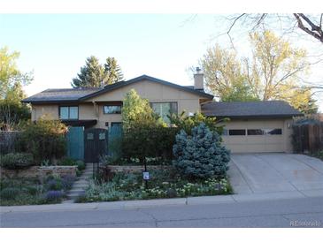 Charming two-story home with lush landscaping and a private front entrance, complemented by an attached two-car garage at 8095 E Lehigh Ave, Denver, CO 80237