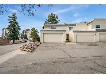 A charming townhouse featuring two single-car garages, a landscaped front, and a well-maintained exterior at 2960 S Parker Ct, Aurora, CO 80014