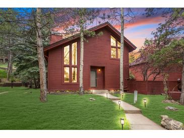 Charming two-story home with a well-manicured lawn and inviting walkway, perfect for curb appeal at 23646 Genesee Village Rd, Golden, CO 80401