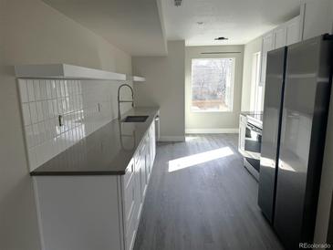 Modern kitchen featuring sleek countertops, stainless steel appliances, and ample natural light at 1642 N Lafayette St # 5, Denver, CO 80218