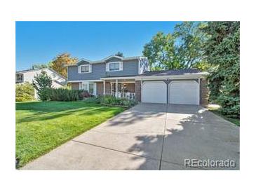 Charming two-story home featuring a well-manicured lawn and a spacious two-car garage at 3270 S Krameria St, Denver, CO 80222
