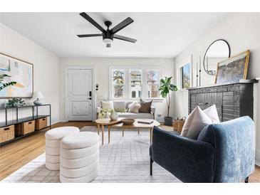 Bright living room features hardwood floors, a modern ceiling fan, and stylish, comfortable furniture at 1445 Ash St, Denver, CO 80220