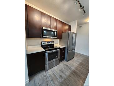 Modern kitchen features stainless steel appliances, sleek countertops, and rich dark cabinetry at 9220 Wilde Ln # 102, Parker, CO 80134
