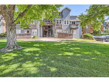 Apartment building exterior featuring a well-maintained lawn and wood accents at 7897 Allison Way # 304, Arvada, CO 80005