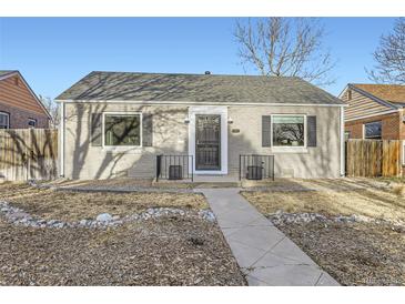 Charming home with gray brick, black shutters, metal railings, and a walkway leading to the front door at 2555 Hudson St, Denver, CO 80207
