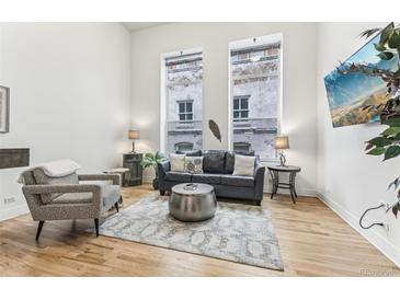 Spacious living room with hardwood floors, large windows, and comfortable seating at 720 16Th St # 518, Denver, CO 80202