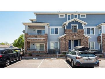 Inviting exterior of a multi-story home with stone accents and a private balcony at 5255 Memphis St # 315, Denver, CO 80239