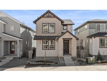 Charming two-story home features a stone facade, neutral siding, and well-maintained landscaping in front at 7306 Watercress Dr, Littleton, CO 80125