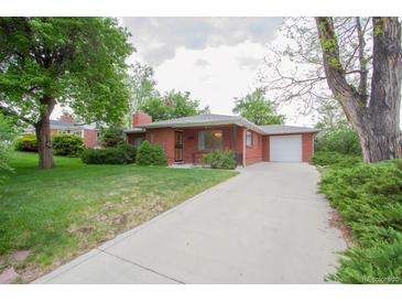 Charming single-story red brick home with a long driveway, lush green lawn, and mature trees at 3222 Fenton St, Wheat Ridge, CO 80212
