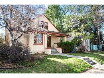 Charming brick home with a cozy front porch and a well-manicured lawn with mature trees at 461 N Marion St, Denver, CO 80218