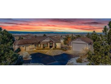 Beautiful single Gathering home featuring stunning mountain views and a meticulously manicured lawn at 3535 Medallion Rd, Castle Rock, CO 80104