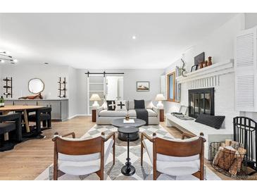 Cozy living room featuring a brick fireplace and modern decor, perfect for relaxing or entertaining at 11 S Albion St, Denver, CO 80246