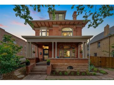 Charming red brick home with a welcoming front porch and detailed architectural features at 1154 N Clarkson St, Denver, CO 80218