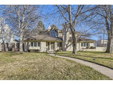 Stunning two-story home with manicured lawn and mature trees at 2 Elm St, Denver, CO 80220