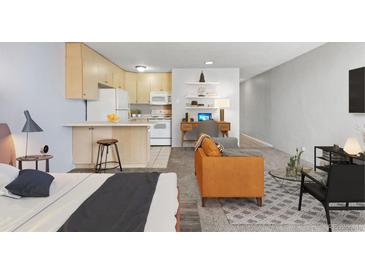 Inviting living area boasts an open layout, a well-equipped kitchen, a desk area, and stylish decor at 2500 S York St # 410, Denver, CO 80210