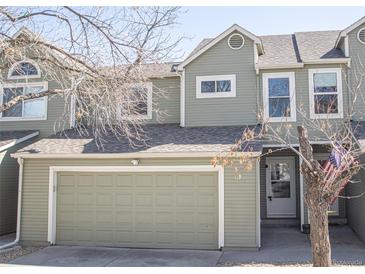 Inviting two-story townhome features a two-car garage, charming curb appeal, and tasteful neutral-toned siding at 11205 Holly St, Thornton, CO 80233