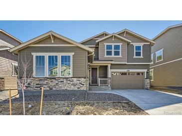 Beautiful two-story home with stone accents, neutral siding, and a two-car garage at 4652 Windmill Dr, Brighton, CO 80601