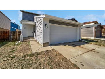 Charming home featuring a two-car garage, light-colored brick, and a well-maintained front yard at 11813 Grant St, Northglenn, CO 80233