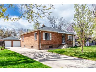 Charming brick home with a well-manicured lawn and a detached two-car garage, offering both curb appeal and practicality at 4433 S Washington St, Englewood, CO 80113