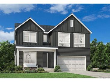 Charming two-story home with a modern dark gray exterior, attached garage, and inviting front porch seating at 7175 S Youngfield Way, Littleton, CO 80127