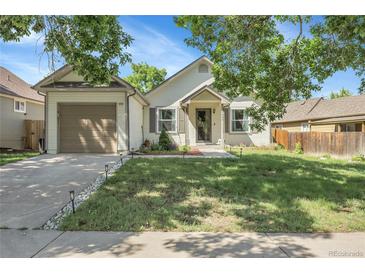 Charming single-Gathering home with a well-maintained front yard and an attached two-car garage, with a lovely lawn at 17499 E Whitaker Dr, Aurora, CO 80015