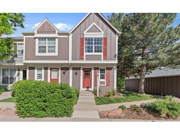 Charming two-story townhouse with red door, red shutters, and well-manicured landscaping at 1035 Milo Cir # B, Lafayette, CO 80026