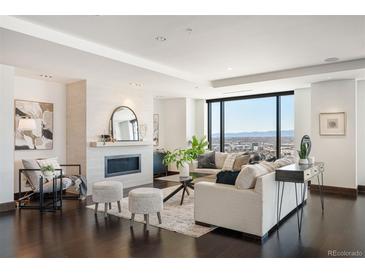 Bright living room features modern fireplace, floor-to-ceiling windows, and sleek, comfortable furnishings at 1133 14Th St # 2300, Denver, CO 80202