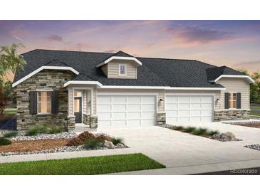 Charming single-story home with a stone facade, attached two-car garage, and well-manicured lawn at 3379 N Denali St, Aurora, CO 80019