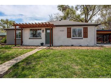 Charming single-story home with a pergola, light gray brick and attractive landscaping at 6220 W 11Th Pl, Lakewood, CO 80214