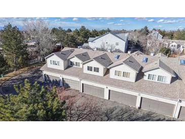 An aerial view of townhome garages with gray doors and light siding on a sunny day at 12327 E Tennessee Dr # 107, Aurora, CO 80012