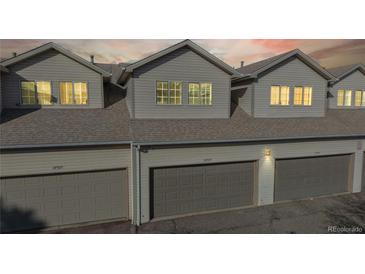 Gray townhome garages provide secure parking, with windows allowing natural light into the upper levels at 12327 E Tennessee Dr # 107, Aurora, CO 80012