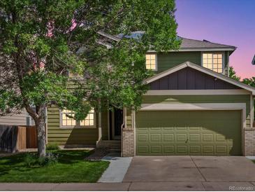 Charming two-story home with a well-maintained lawn and attached two-car garage at 11082 Fillmore Way, Northglenn, CO 80233