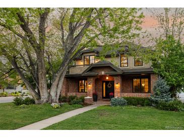 Charming two-story brick home with a large front yard and mature tree at 301 Fairfax St, Denver, CO 80220