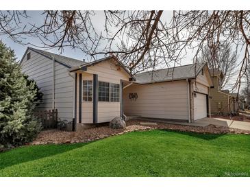 Charming home exterior with well-maintained lawn, stone landscaping, and attached garage at 2132 Boise Ct, Longmont, CO 80504