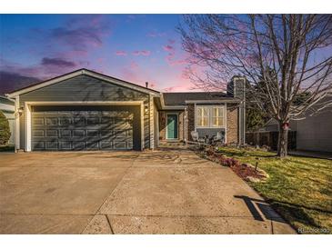 Charming single-Gathering home features a well-maintained yard and an attached two-car garage at 8893 W Ontario Ave, Littleton, CO 80128