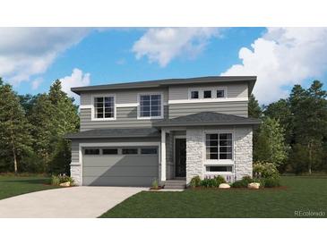 Beautiful two-story home featuring stone accents, gray siding, complemented by professional landscaping and a two car garage at 455 S Salida St, Aurora, CO 80017