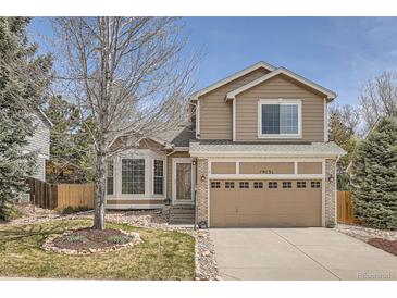 Charming two-story home with a well-maintained lawn and beautiful landscaping at 19131 E Crestridge Cir, Aurora, CO 80015