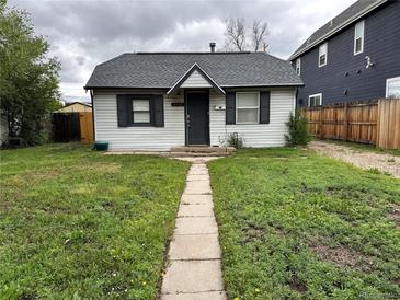 Charming home featuring a well-maintained front yard and pathway leading to the inviting entrance at 2429 S Cherokee St, Denver, CO 80223