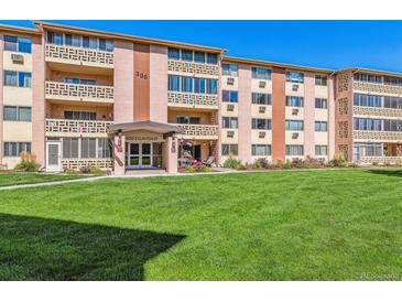 Attractive exterior of a mid-rise apartment building with landscaping at 300 S Clinton St # 8C, Denver, CO 80247