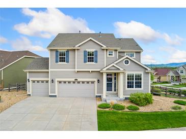 Charming two-story home featuring a three-car garage, and well-manicured lawn at 19316 W 84Th Pl, Arvada, CO 80007