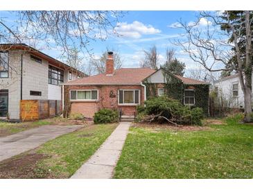 Charming brick home featuring a landscaped front yard and inviting walkway at 1665 S Saint Paul St, Denver, CO 80210