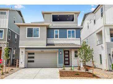 Contemporary two-story home with a two-car garage and modern architectural details and landscaping at 8213 Butte Creek St, Littleton, CO 80125