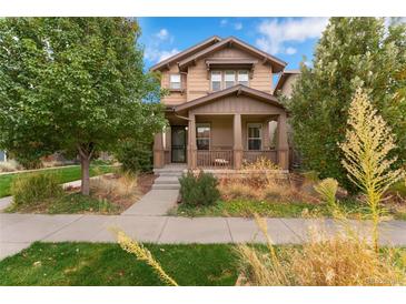 Beautiful two-story home with a landscaped front yard and porch at 7932 E 49Th Pl, Denver, CO 80238