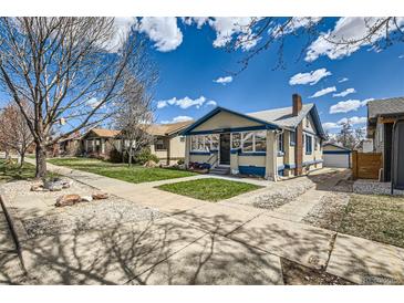 Charming home with a well-maintained lawn and inviting curb appeal on a beautiful, sunny day at 4556 Decatur St, Denver, CO 80211