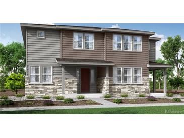 Charming two-story home featuring stone accents, horizontal siding, and a well-maintained front yard at 1422 Hudson Pl, Longmont, CO 80501