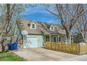 Charming home featuring an attached garage, well-kept lawn, and lovely curb appeal at 1065 6Th St, Berthoud, CO 80513