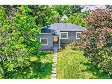 Charming single-story home with lush, mature trees and manicured lawn at 1901 S Adams St, Denver, CO 80210