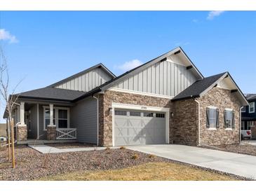 Charming single Gathering home boasts a two-car garage, stone accents, and inviting curb appeal at 17233 W 93Rd Pl, Arvada, CO 80007