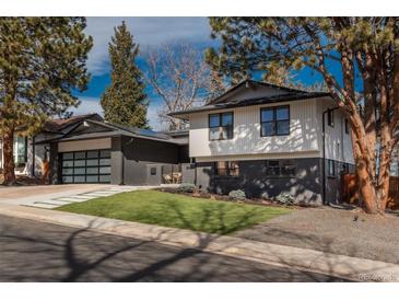 Two story home has a modern design with black brick and white siding and professional landscaping at 7341 E Jarvis Pl, Denver, CO 80237